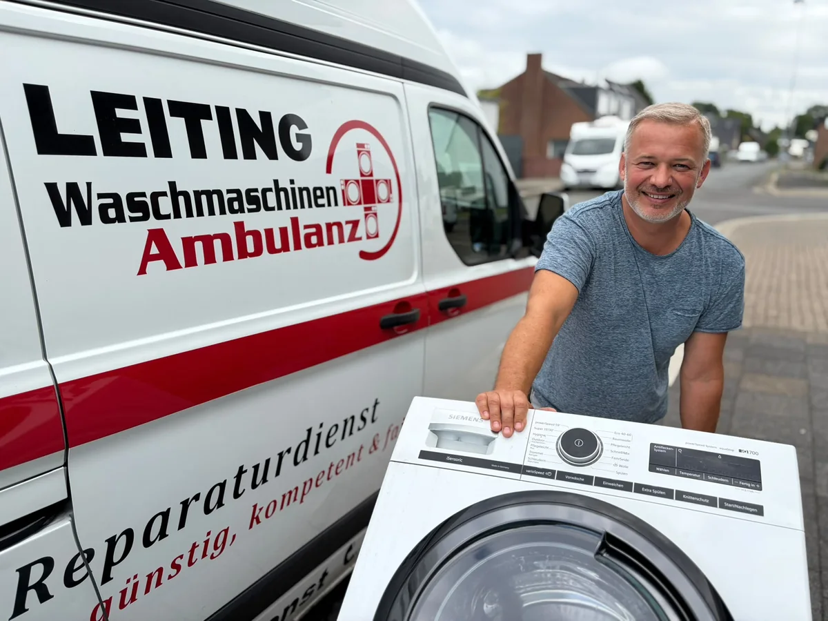 Techniker der Waschmaschinen-Ambulanz mit Waschmaschine am Servicewagen